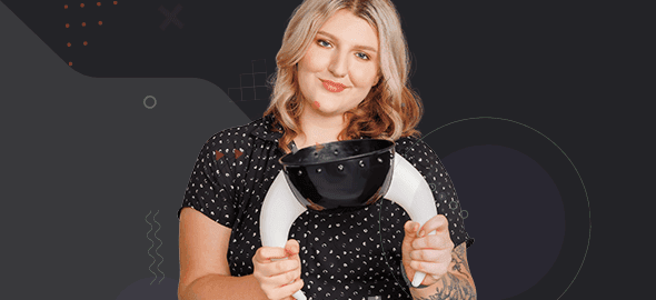 A smiling girl holds a helmet