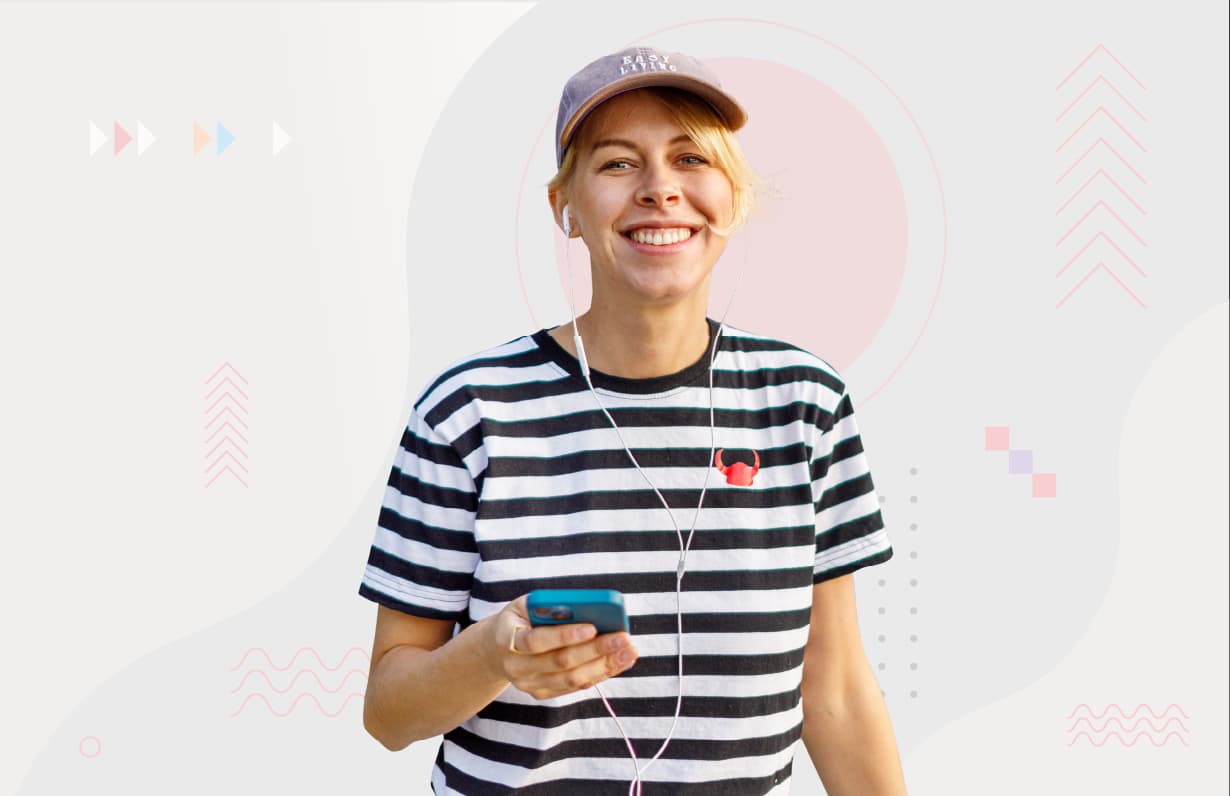 A smiling girl wearing a black-and-white striped shirt with a small printed helmet on it.