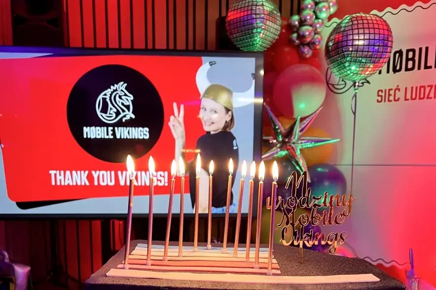 mobile vikings birthday cake with candles in the background mv logo