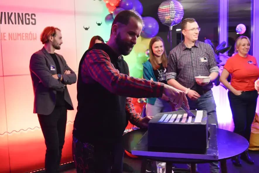 bearded man cutting cake at mobile vikings birthday